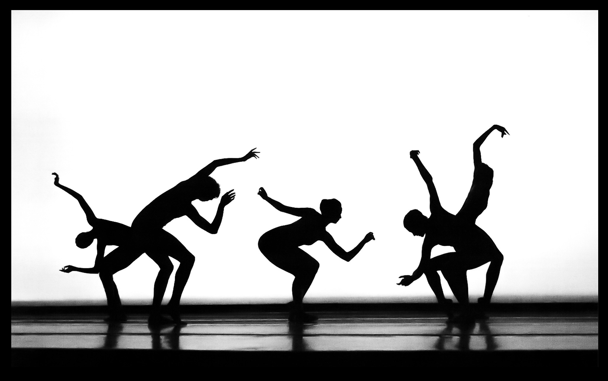 two people sitting on a ledge talking